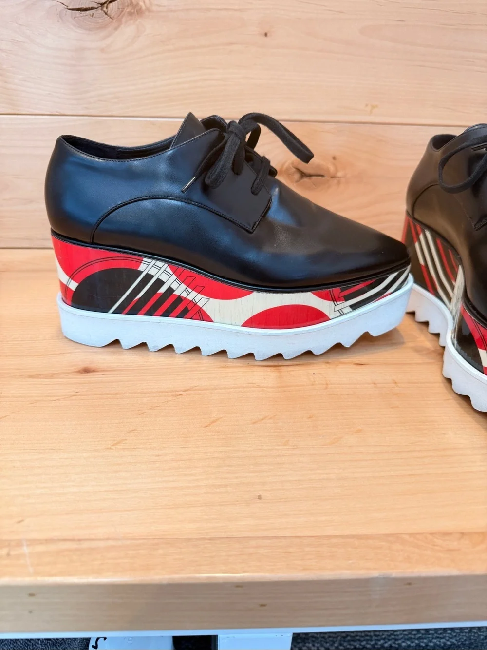 Stella McCartney Black Leather Elyse Platform Shoes with abstract design.